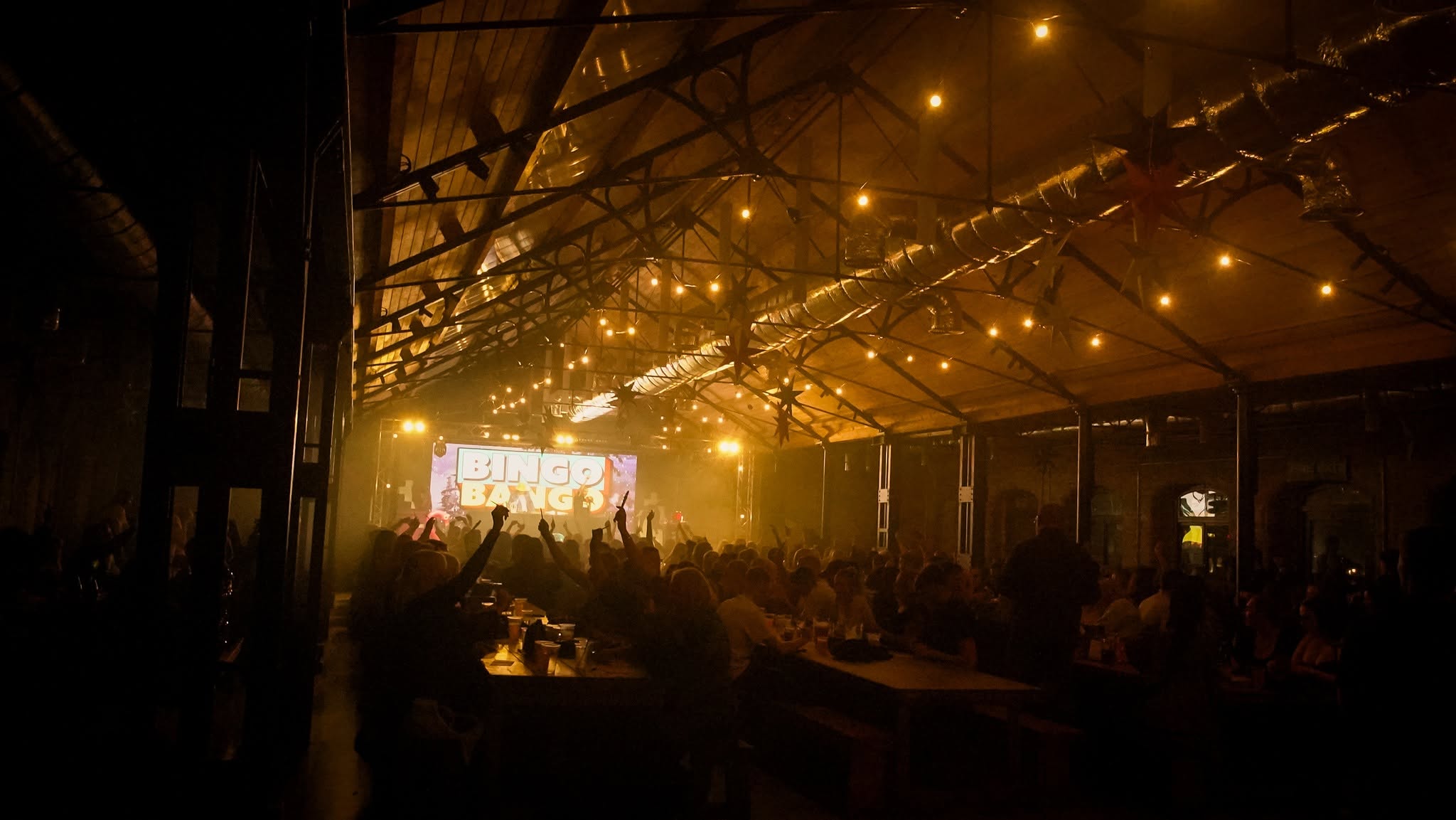 A live event glowing beneath The Carding Shed roof
